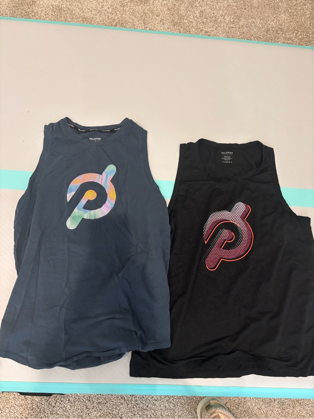Peloton women’s medium Tank Tops in Navy and Black with Multicolor Logos